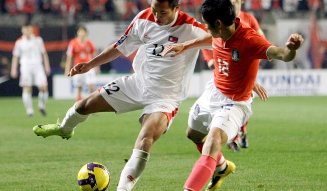 FILE - In this April 1, 2009, file photo, North Korea&#x27;s Jong Tae Se, left, fights for the ball against South Korea&#x27;s Lee Young-pyo during their 2010 FIFA World Cup Asia group 2 qualifying soccer match at Seoul World Cup Stadium in Seoul, South Korea. The South Korean men&#x27;s national soccer team&#x27;s path to the 2022 World Cup in Qatar will include a crucial road match against North Korea, but it&#x27;s unclear whether a rare match between the Koreas in Pyongyang will materialize considering the political tension between the rivals. (AP Photo/ Lee Jin-man, File)