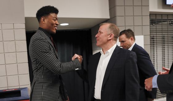 Washington Wizards first round draft pick Rui Hachimura, left, shakes hands with Wizards senior vice president of basketball operations Tommy Sheppard as they arrive for an NBA basketball press conference at Capital One Arena in Washington, Friday, June 21, 2019.(AP Photo/Pablo Martinez Monsivais)**FILE****
