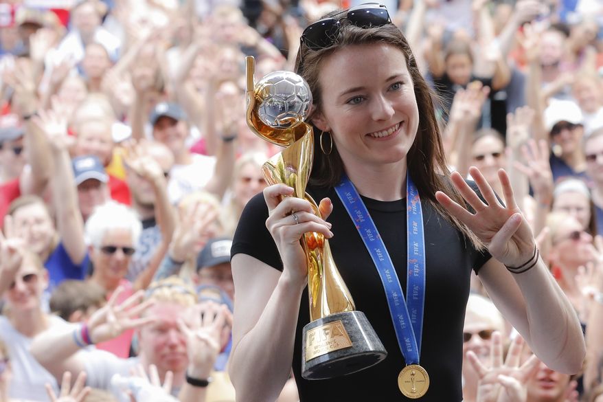 U.S. women's soccer team player Rose Lavelle holds her trophy as she attends a welcome event in her honor at Fountain Square, Friday, July 19, 2019, in Cincinnati. The U.S. national team beat the Netherlands 2-0 to capture a record fourth Women's World Cup title. Lavelle scored the second goal for the U.S. in the victory. (AP Photo/John Minchillo) ** FILE **