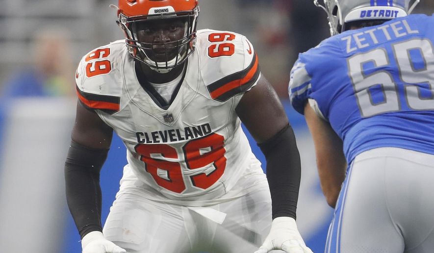 FILE - In this Aug. 30, 2018, file photo, Cleveland Browns offensive tackle Desmond Harrison (69) defends the line as Detroit Lions defensive end Anthony Zettel (69) rushes during the first half of an NFL football preseason game in Detroit. Arizona Cardinals' Harrison who was released this week has surrendered to police in North Carolina after a warrant was issued for his arrest on an assault charge. A news release from the Greensboro Police Department says Harrison turned himself in to authorities Friday, July 19, 2019. Harrison was claimed last month by the Cardinals after he was cut by the Browns. (AP Photo/Paul Sancya, File)
