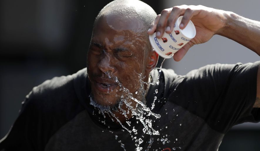 Baltimore Orioles outfielder Keon Broxton douses himself with water while taking a break between fielding and batting practice prior to a baseball game against the Boston Red Sox, Friday, July 19, 2019, in Baltimore. A heat wave is hitting Baltimore and heat advisories have been set ahead of a hot weekend. (AP Photo/Julio Cortez)