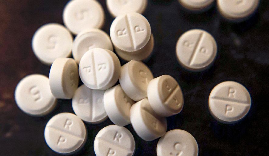 FILE - This Monday, June 17, 2019, file photo, shows 5-mg pills of Oxycodone. Two Ohio counties are asking a judge to find that drugmakers and distributors were not allowed to ship suspicious orders of controlled substances to pharmacies. If a judge sides with the request from Cuyahoga and Summit counties, it would clear the way for the governments to assert that drug companies ignored the regulations as a nationwide opioid crisis continued to grow. (AP Photo/Keith Srakocic)