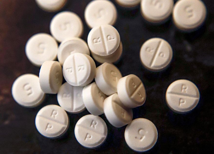 FILE - This Monday, June 17, 2019, file photo, shows 5-mg pills of Oxycodone. Two Ohio counties are asking a judge to find that drugmakers and distributors were not allowed to ship suspicious orders of controlled substances to pharmacies. If a judge sides with the request from Cuyahoga and Summit counties, it would clear the way for the governments to assert that drug companies ignored the regulations as a nationwide opioid crisis continued to grow. (AP Photo/Keith Srakocic)