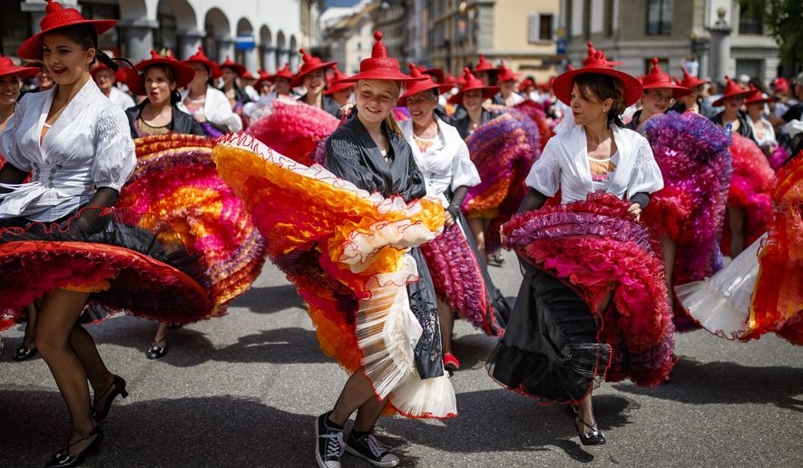 People take part of the &amp;quot;Fete des Vignerons&amp;quot; (winegrowers&#x27; festival in French), parade during the official opening parade prior to the first representation and crowning ceremony in Vevey, Switzerland, Thursday, July 18, 2019. Organized in Vevey by the brotherhood of winegrowers since 1979, the event will celebrate winemaking from July 18 to August 11 this year. (Valentin Flauraud/Keystone via AP)