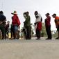 In this April 30, 2019, photo, migrants seeking asylum in the United States line up for a meal provided by volunteers near the international bridge in Matamoros, Mexico. (AP Photo/Eric Gay) **FILE**