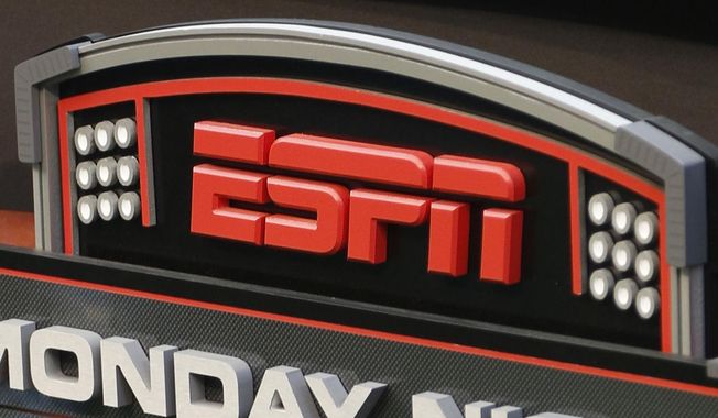 This Sept. 16, 2013, file photo shows the ESPN logo prior to an NFL football game between the Cincinnati Bengals and the Pittsburgh Steelers, in Cincinnati. ESPN is reminding employees of the network&#x27;s policy to avoid talking about politics after radio talk show host Dan Le Batard criticized President Donald Trump and his recent racist comments and ESPN itself on the air this week. (AP Photo/David Kohl, File)