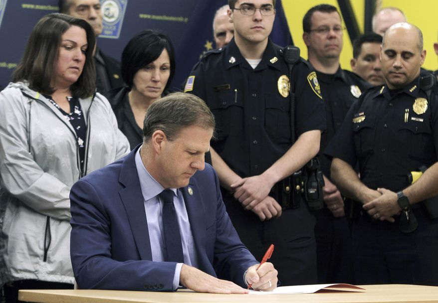 In this May 3, 2019, file photo, New Hampshire Gov. Chris Sununu vetoes a bill that would repeal the death penalty in the state during an event at the Officer Michael Briggs Community Center in Manchester, N.H. (Nick Stoico/The Concord Monitor via AP, File) ** FILE **