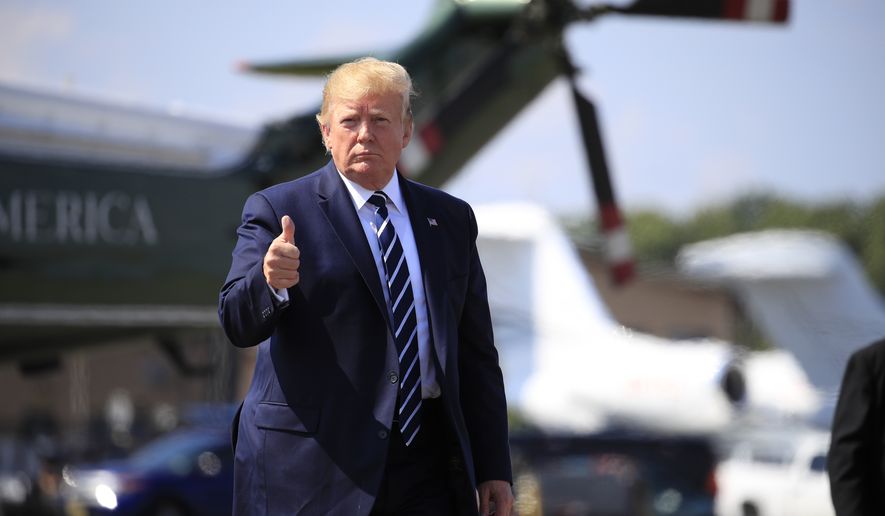 President Donald Trump gives a thumbs up as he walks on the tarmac to board Air Force One at Morristown Municipal Airport, in Morristown, N.J., on his way returning back to the White House Sunday, July 21, 2019. (AP Photo/Manuel Balce Ceneta)