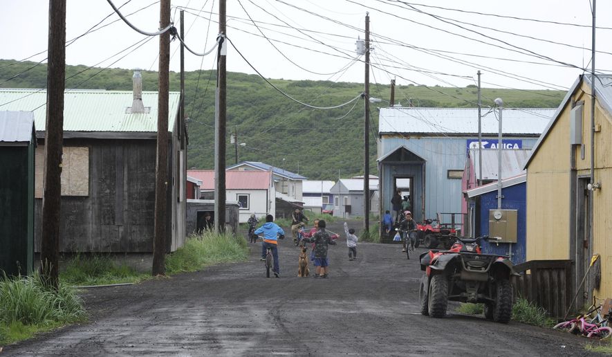 In this Wednesday, June 26, 2019 photo, children play on the main road of Stebbins, a Bering Strait village that is home to 646 people, in Alaska. The city is among over a dozen cities in Alaska that have employed police officers whose criminal records should have prevented them from being hired under state law, the Anchorage Daily News and ProPublica reported Saturday, July 20. (Bill Roth/Anchorage Daily News via AP)