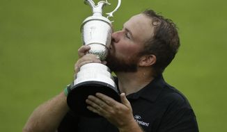 Ireland&#39;s Shane Lowry holds and kisses the Claret Jug trophy after winning the British Open Golf Championships at Royal Portrush in Northern Ireland, Sunday, July 21, 2019.(AP Photo/Matt Dunham)