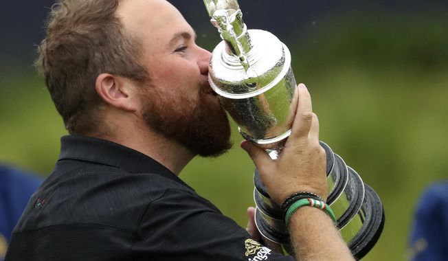 Ireland&#x27;s Shane Lowry holds and kisses the Claret Jug trophy after winning the British Open Golf Championships at Royal Portrush in Northern Ireland, Sunday, July 21, 2019.(AP Photo/Peter Morrison)