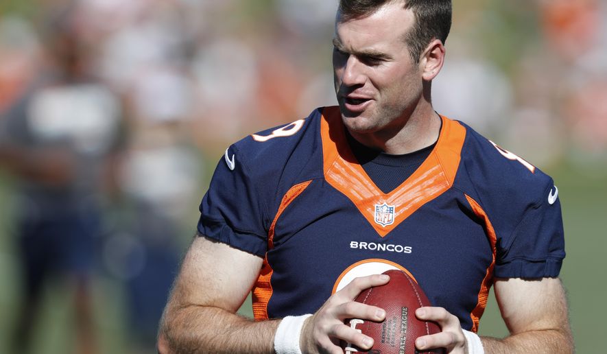 Denver Broncos quarterback Kevin Hogan looks to pass the ball during drills at the team's NFL football training camp Friday, July 19, 2019, in Englewood, Colo. (AP Photo/David Zalubowski)