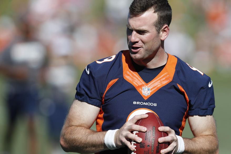 Denver Broncos quarterback Kevin Hogan looks to pass the ball during drills at the team's NFL football training camp Friday, July 19, 2019, in Englewood, Colo. (AP Photo/David Zalubowski)