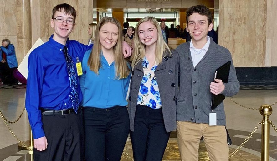 In this Feb. 6, 2019, file photo provided by Providence Health & Services, from left, Sam Adamson, Lori Riddle, Hailey Hardcastle, and Derek Evans pose at the Oregon State Capitol in Salem, Ore. The teens introduced legislation to allow students to take "mental health days" as they would sick days in an attempt to respond to a mental health crisis gripping the state. (Jessica Adamson/Providence Health & Services via AP)