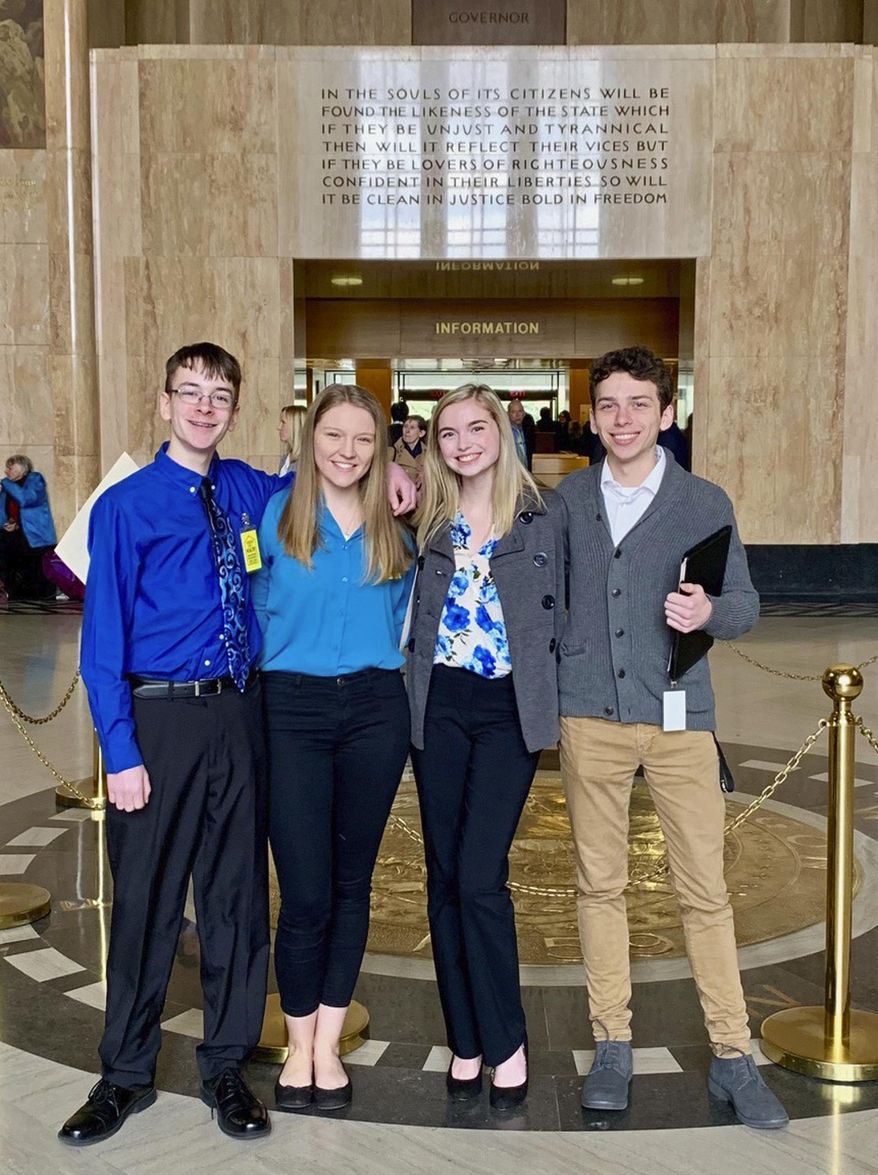 In this Feb. 6, 2019, file photo provided by Providence Health & Services, from left, Sam Adamson, Lori Riddle, Hailey Hardcastle, and Derek Evans pose at the Oregon State Capitol in Salem, Ore. The teens introduced legislation to allow students to take "mental health days" as they would sick days in an attempt to respond to a mental health crisis gripping the state. (Jessica Adamson/Providence Health & Services via AP)