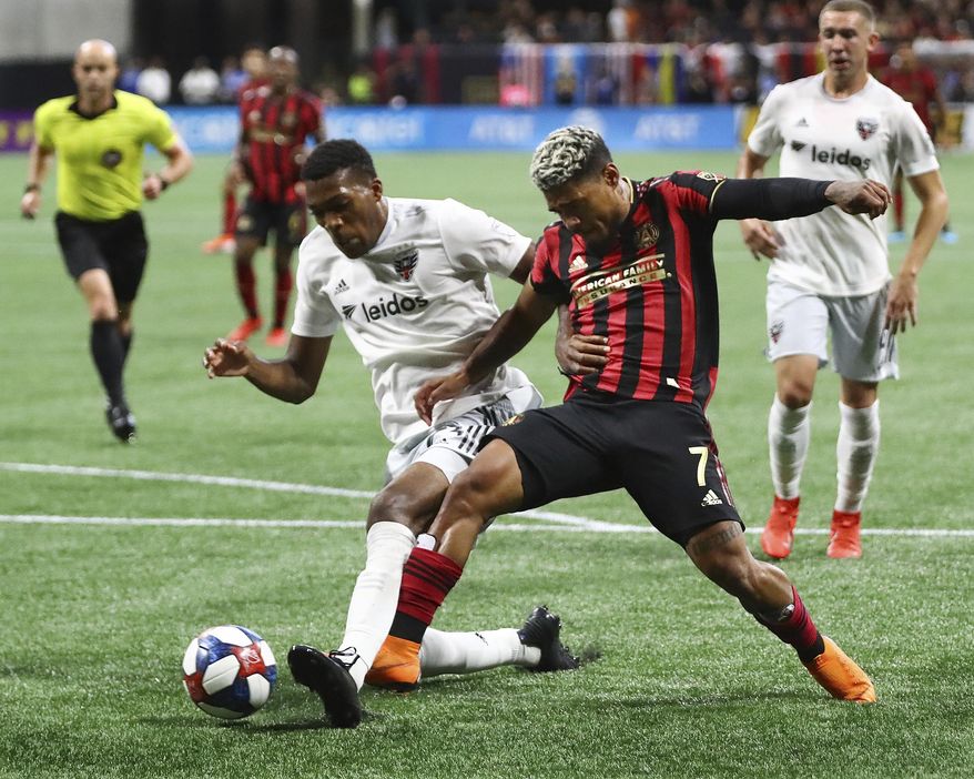 Atlanta United forward Josef Martinez, right, and D.C. United defender Donovan Pines, left, battle for the ball in front of the D.C. United goal during the first half in a soccer match on Sunday, July 21, 2019, in Atlanta. (Curtis Compton/Atlanta Journal-Constitution via AP)