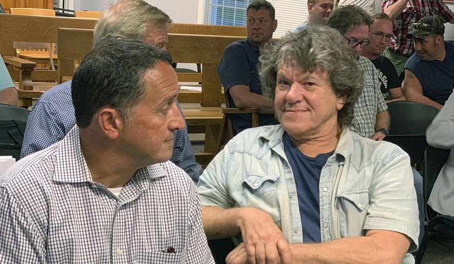 Michael Lang, right, Woodstock 50 co-producer and co-founder, sits in Vernon Town Hall before a planning board hearing in Vernon, N.Y., for his appeal to grant a permit for the Woodstock 50 music festival. (Edward Harris/Observer-Dispatch via AP)