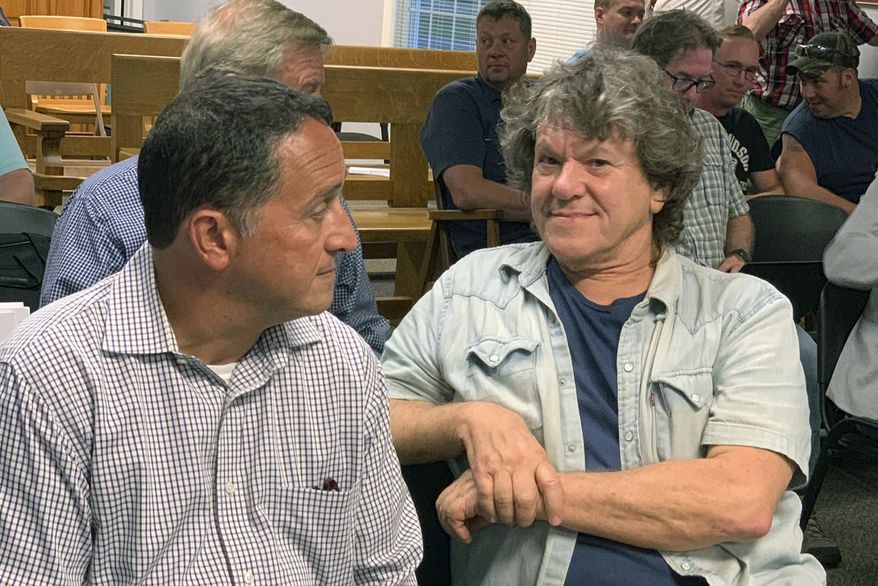 Michael Lang, right, Woodstock 50 co-producer and co-founder, sits in Vernon Town Hall before a planning board hearing in Vernon, N.Y., for his appeal to grant a permit for the Woodstock 50 music festival. (Edward Harris/Observer-Dispatch via AP)