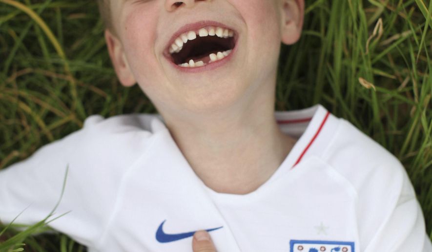 In this undated photo released by the Duke and Duchess of Cambridge on Sunday, July 21, 2019, Britain's Prince George poses for a photo taken by his mother, Kate, the Duchess of Cambridge, in the garden of their home at Kensington Palace, London. Prince George will celebrate his sixth birthday on Monday, July 22. (The Duchess of Cambridge via AP)