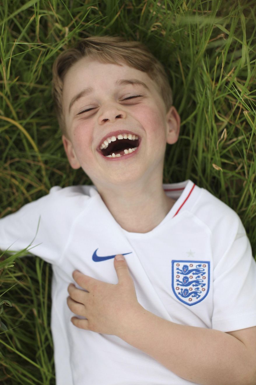 In this undated photo released by the Duke and Duchess of Cambridge on Sunday, July 21, 2019, Britain's Prince George poses for a photo taken by his mother, Kate, the Duchess of Cambridge, in the garden of their home at Kensington Palace, London. Prince George will celebrate his sixth birthday on Monday, July 22. (The Duchess of Cambridge via AP)