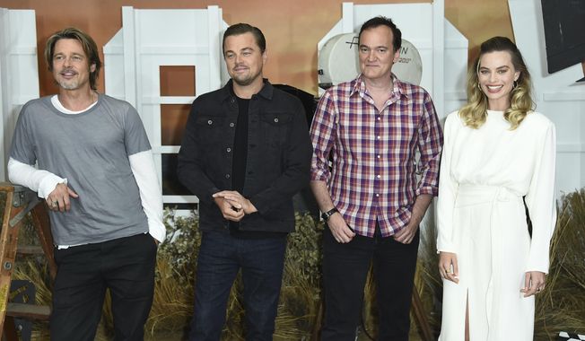 FILE - In this July 11, 2019 file photo, Brad Pitt, from left, Leonardo DiCaprio, Quentin Tarantino and Margot Robbie attend the photo call for &amp;quot;Once Upon a Time in Hollywood&amp;quot; at the Four Seasons Hotel in Los Angeles. The film opens on July 26. (Photo by Jordan Strauss/Invision/AP, File)
