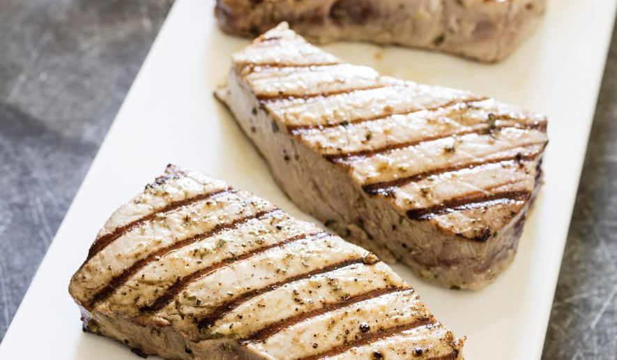 This undated photo provided by America's Test Kitchen in July 2019 shows Grilled Tuna Steaks with Vinaigrette in Brookline, Mass. This recipe appears in the cookbook “Master of the Grill.” (Daniel J. van Ackere/America's Test Kitchen via AP)
