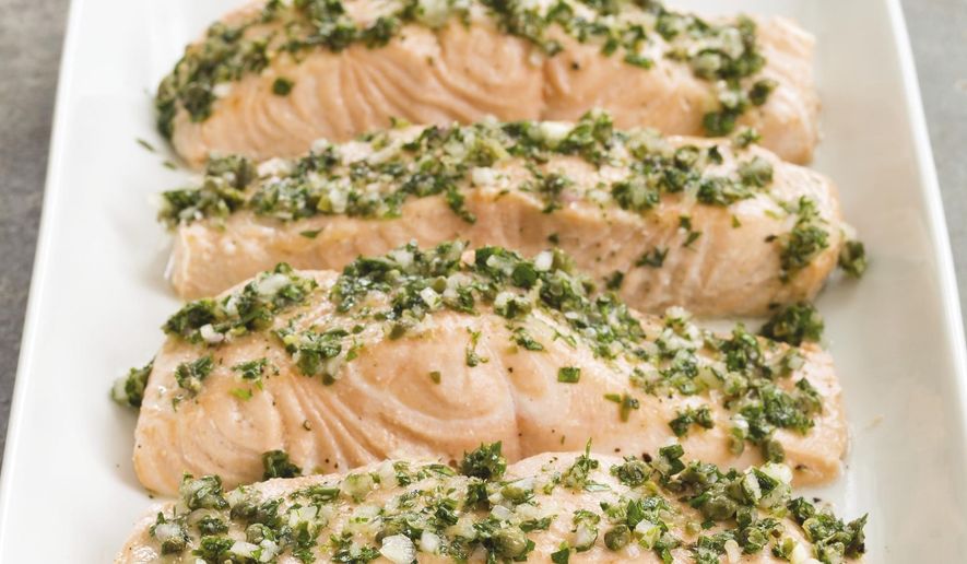 This undated photo provided by America's Test Kitchen in July 2019 shows Poached Salmon with Herb and Caper Vinaigrette in Brookline, Mass. This recipe appears in "The Complete Diabetes Cookbook." (Daniel J. van Ackere/America's Test Kitchen via AP)