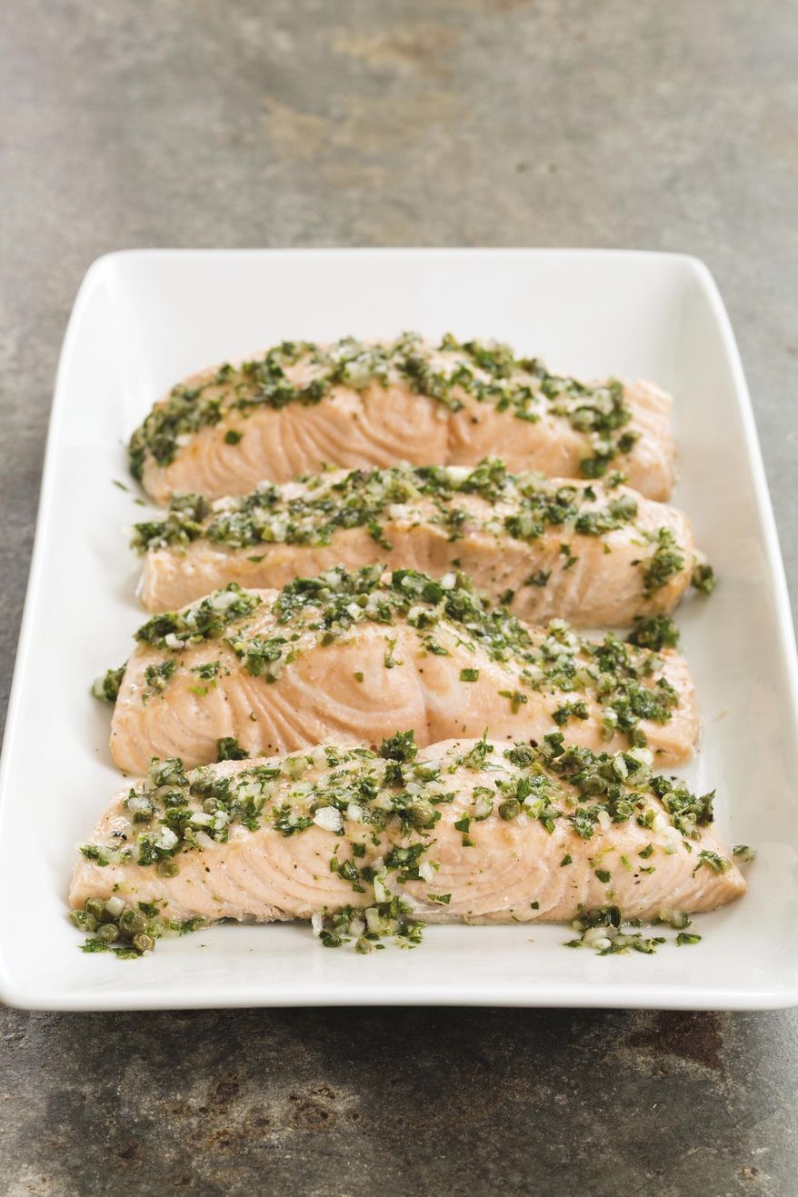 This undated photo provided by America's Test Kitchen in July 2019 shows Poached Salmon with Herb and Caper Vinaigrette in Brookline, Mass. This recipe appears in "The Complete Diabetes Cookbook." (Daniel J. van Ackere/America's Test Kitchen via AP)