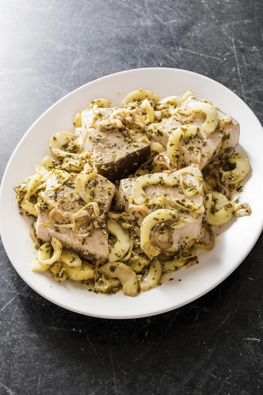 This undated photo provided by America's Test Kitchen in July 2019 shows Swordfish en Cocotte with Shallots, Cucumber and Mint in Brookline, Mass. This recipe appears in the cookbook "Complete Mediterranean." (Daniel J. van Ackere/America's Test Kitchen via AP)