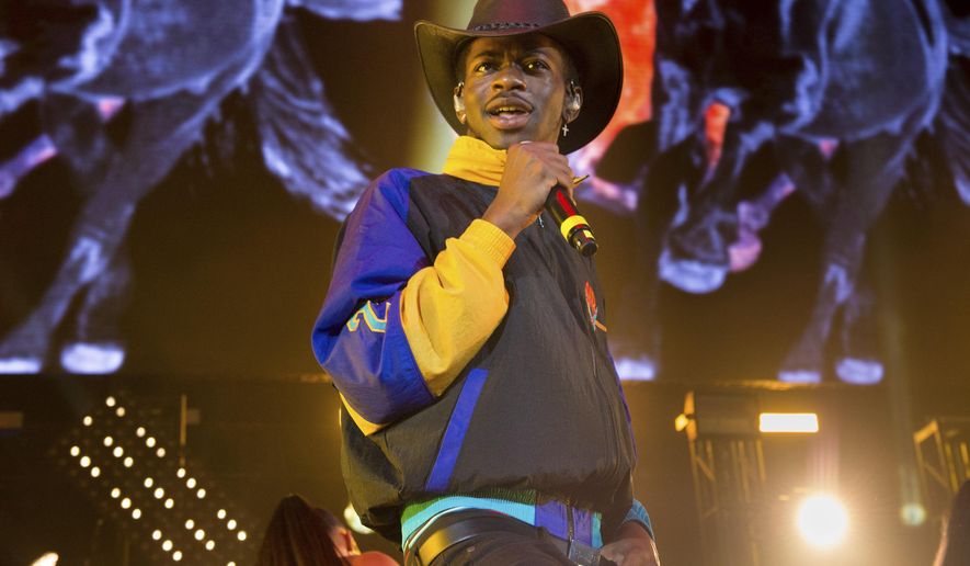 FILE - This June 1, 2019 file photo shows Lil Nas X performing at HOT 97 Summer Jam 2019 in East Rutherford, N.J. The rapper has taken his &amp;quot;Old Town Road&amp;quot; to the top of the Billboard charts for 16 weeks, tying a record set by Mariah Carey and Luis Fonsi. (Photo by Scott Roth/Invision/AP, File)