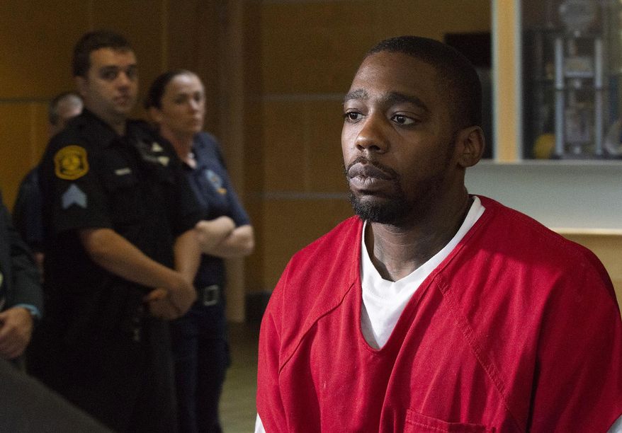 Christian Bey walks through the Pittsburgh Police Headquarters on the North Side on Monday, July 22, 2019. Police say Bey has been charged with criminal homicide in the shooting death of off-duty Pittsburgh Police Officer Calvin Hall more than a week ago. (Christian Snyder/Pittsburgh Post-Gazette via AP)