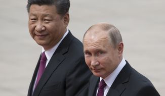 In this June 8, 2018, Russian President Vladimir Putin, right, and Chinese President Xi Jinping walk together during a welcome ceremony outside the Great Hall of the People in Beijing, China. If Donald Trump is serious about his public courtship of Vladimir Putin, he may want to take pointers from one of the Russian leader&#x27;s longtime suitors: Chinese President Xi Jinping. In this political love triangle, Putin and Xi are tied by strategic need and a rare dose of personal affection, while Trump&#x27;s effusive display in Helsinki showed him as an earnest admirer of the man leading a country long considered America&#x27;s adversary. (AP Photo/Alexander Zemlianichenko, File)