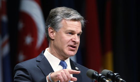 In this  June 7, 2019, file photo, Director of the Federal Bureau of Investigation Christopher Wray gestures as he speaks during a graduation ceremony for students of the Federal Bureau of Investigations National Academy at the FBI training facility in Quantico, Va. (AP Photo/Steve Helber, File)