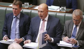 In this Tuesday, July 23, 2019, photo, Home Affairs Minister Peter Dutton, center, interjects during debate in Australia&#39;s Parliament House in Canberra. Australia is set to pass laws that would allow the government to prevent suspected extremists from returning home for up to two years.(AP Photo/Rod McGuirk)