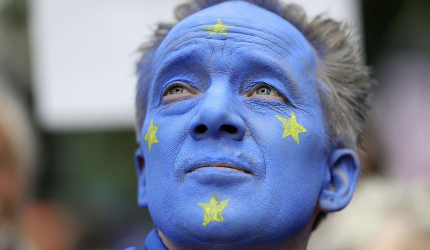 A Pro-European Union supporter with his face painted in the colours of the European Union Flag, takes part in the March for Change, in London, Saturday July 20, 2019. (Aaron Chown/PA via AP)