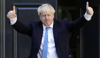 Newly elected leader of the Conservative party Boris Johnson arrives at Conservative party HQ in London, Tuesday, July 23, 2019. Brexit-hard-liner Boris Johnson, one of Britain’s most famous and divisive politicians, won the race to lead the governing Conservative Party on Tuesday, and will become the country’s next prime minister in a little over 24 hours. (Aaron Chown/PA via AP)