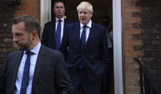 Conservative Party leadership contender Boris Johnson, right, leaves his office in London, Monday July 22, 2019.  Voting closes Monday in the ballot to elect Britain&#39;s next prime minister, from the two contenders Jeremy Hunt and Boris Johnson, as critics of likely winner Boris Johnson condemned his vow to take Britain out of the European Union with or without a Brexit deal.(Kirsty O&#39;Connor/PA via AP)