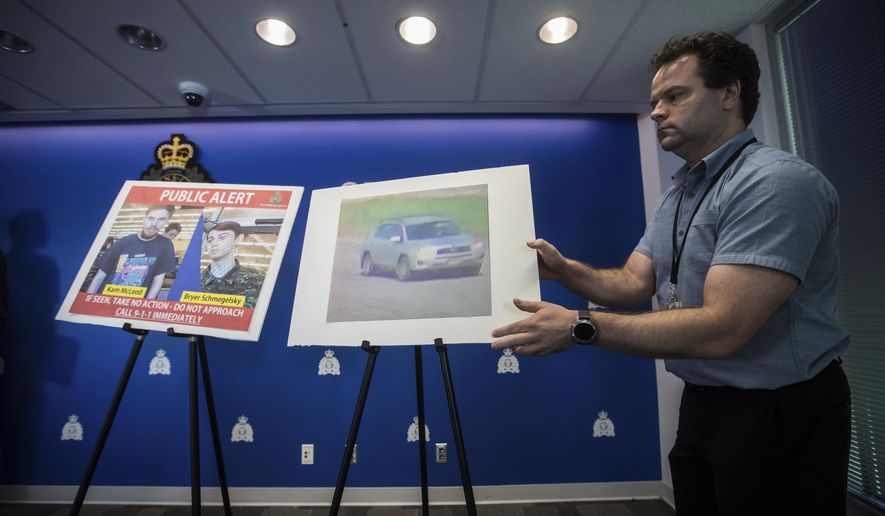 Security camera images of Kam McLeod, 19, and Bryer Schmegelsky, 18, and a Toyota RAV4 SUV are placed on display before an Royal Canadian Mounted Police news conference in Surrey, British Columbia, on Tuesday, July 23, 2019. RCMP say two British Columbia teenagers who were first thought to be missing are now considered suspects in the deaths of three people in northern British Columbia. The bodies of Australian Lucas Fowler, his girlfriend Chynna Deese, of Charlotte, N.C., and an unidentified man were found a few kilometers from the teens' burned-out vehicle. (Darryl Dyck/The Canadian Press via AP)