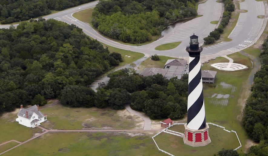 FILE - This Sept. 15, 2018, file photo, shows the Cape Hatteras lighthouse in Buxton, N.C. The National Park Service said Tuesday, July 23, 2019, that 39-year-old Jamie Lester Underwood, of Winston-Salem, pleaded guilty to vandalizing the lighthouse's original bronze door last year. A federal judge ordered Underwood to pay $1,922 in restitution for repairs and placed him on one year of probation. (AP Photo/Steve Helber, File)