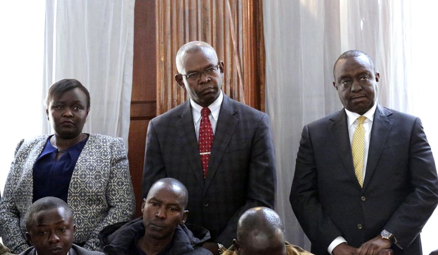 From left, Principal Secretary Ministry of East Africa Community Susan Jemtai Koech, Principal Secretary National Treasury Kamau Thugge, and Cabinet Secretary for National Treasury Henry Kiplagat Rotich appear with other suspects accused of corruption, at the Mililani law court in Nairobi, Tuesday, July 23, 2019. Kenya’s finance minister Tuesday denied fraud-related charges over contracts for the construction of two dams in the country’s west. This is the first time a Kenyan finance minister has been charged while in office. Henry Rotich and 14 other officials appeared in court after spending the night in police custody. (AP Photo/Khalil Senosi)