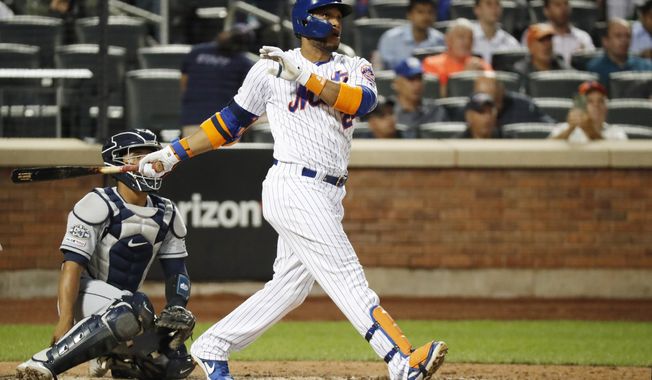 New York Mets&#x27; Robinson Cano watches his solo home run during the fourth inning of a baseball game against the San Diego Padres, Tuesday, July 23, 2019, in New York. San Diego Padres catcher Francisco Mejia is behind the plate. (AP Photo/Kathy Willens)
