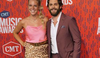 FILE - This June 5, 2019 file photo shows Lauren Akins, left, and Thomas Rhett at the CMT Music Awards in Nashville, Tenn. Rhett  announced on social media that his wife is pregnant with another girl. (AP Photo/Sanford Myers, File)