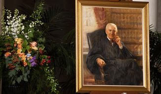 A portrait of the late Supreme Court Justice John Paul Stevens is displayed in the Great Hall of the U.S. Supreme Court, Monday, July 22, 2019, in Washington, as the former justice lies in repose at the court. (AP Photo/Manuel Balce Ceneta)