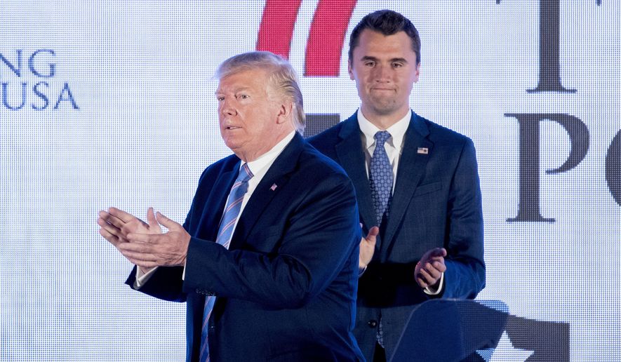 In this file photo from July 23, 2019, President Donald Trump is joined on stage with Turning Point USA Founder Charlie Kirk as he finishes speaking at Turning Point USA Teen Student Action Summit at the Marriott Marquis in Washington. (AP Photo/Andrew Harnik) **FILE**