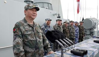 In this April 12, 2018, file photo released by Xinhua News Agency, Chinese President Xi Jinping speaks after reviewing the Chinese People&#39;s Liberation Army (PLA) navy fleet in the South China Sea. (Li Gang/Xinhua via AP, File)