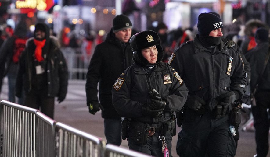 NYPD officers patrol in Times Square during New Year&#39;s Eve celebrations, Sunday, Dec. 31, 2017, in New York. (AP Photo/Go Nakamura)