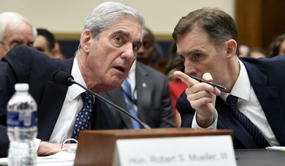 Former special counsel Robert Mueller, left, talks with his top aide in the investigation Aaron Zebley, right, during a House Judiciary Committee hearing on Capitol Hill in Washington, Wednesday, July 24, 2019, on on his report on Russian election interference. (AP Photo/Susan Walsh)