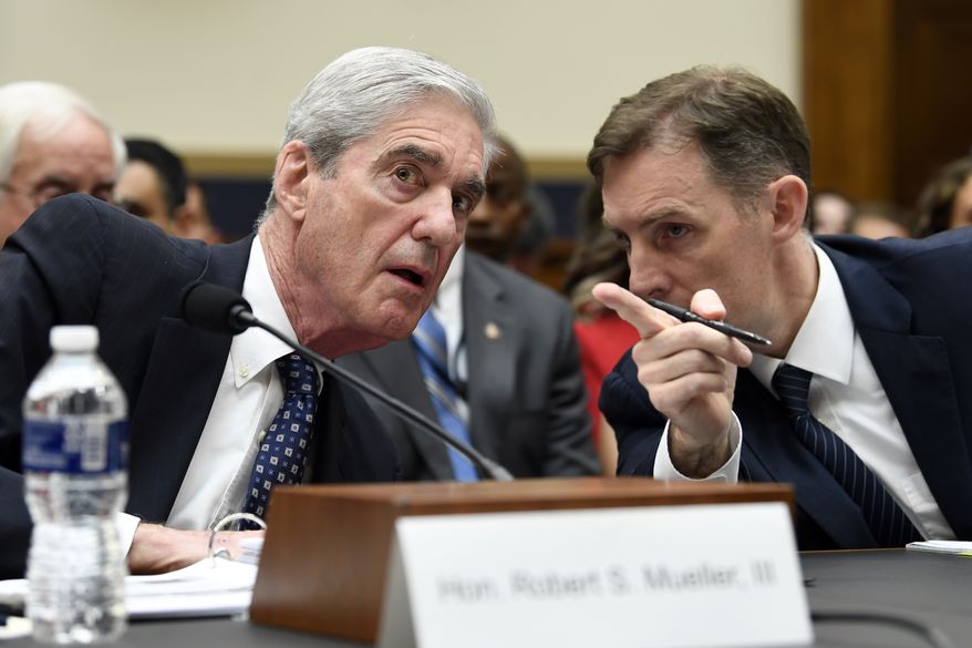 Former special counsel Robert Mueller, left, talks with his top aide in the investigation Aaron Zebley, right, during a House Judiciary Committee hearing on Capitol Hill in Washington, Wednesday, July 24, 2019, on on his report on Russian election interference. (AP Photo/Susan Walsh)