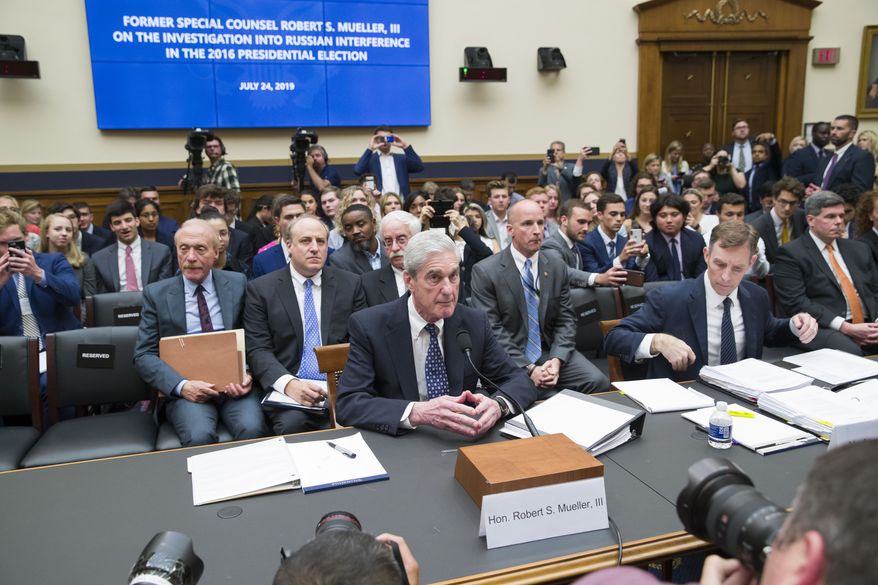 Former special counsel Robert Mueller, accompanied by his top aide in the investigation Aaron Zebley, is seated to testify before the House Intelligence Committee hearing on his report on Russian election interference, on Capitol Hill, Wednesday, July 24, 2019 in Washington. (AP Photo/Alex Brandon)