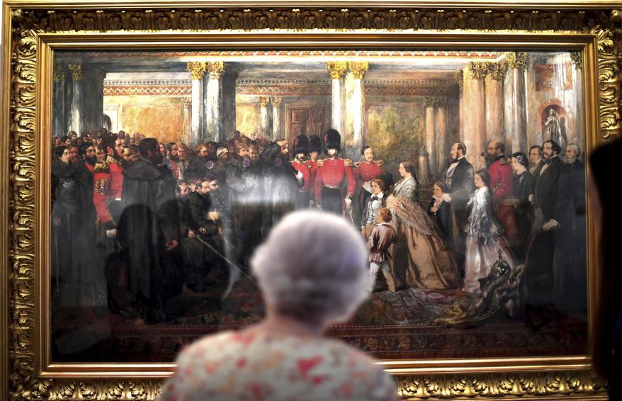 Britain's Queen Elizabeth II looks at a painting of Queen Victoria inspecting wounded Coldstream Guardsmen, 1855, by artist John Gilbert, as part of the exhibition to mark the 200th anniversary of the birth of Queen Victoria, for the Summer Opening of Buckingham Palace, London, Wednesday July 17, 2019. Queen Elizabeth toured the exhibition featuring the story of her great-grandmother Queen Victoria. (Victoria Jones/Pool via AP)